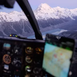 View from a helicopter cockpit flying toward Aoraki Mount Cook and Tasman Glacier