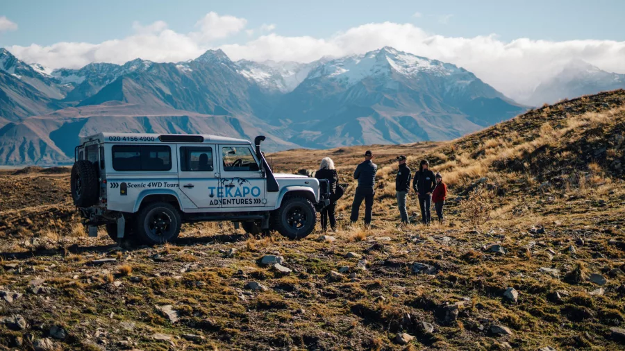 Guests on a private 4WD tour pause to admire the Southern Alps in the Mackenzie Basin