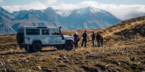 Guests on a private 4WD tour pause to admire the Southern Alps in the Mackenzie Basin