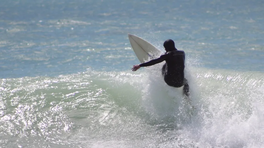 Surfer catching a wave at Jack’s Point, Timaru