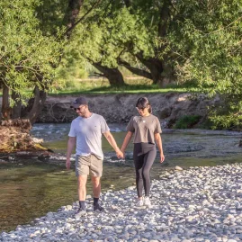 Couple walking hand in hand along the Twizel river trail