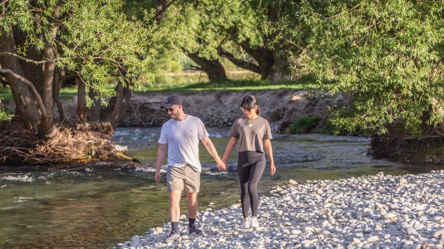 Couple walking hand in hand along the Twizel river trail