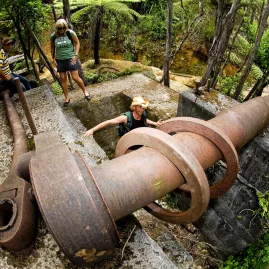 Visitors exploring gold mining relics in Karangahake Gorge