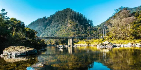 Swing bridge over river in Karangahake Gorge
