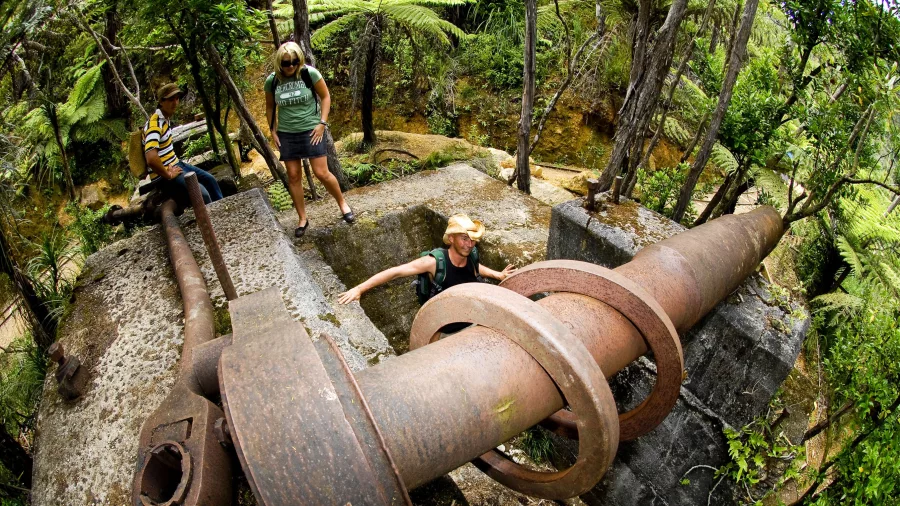 Visitors exploring gold mining relics in Karangahake Gorge