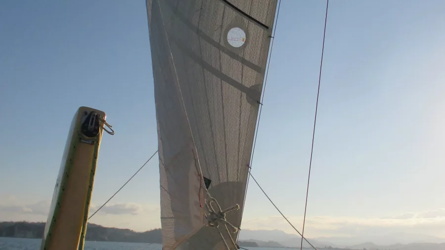 Close-up of the sail and rigging on Boom Sailing’s catamaran under afternoon light