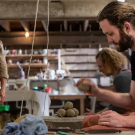 Male student forming clay pieces during a Driving Creek pottery workshop