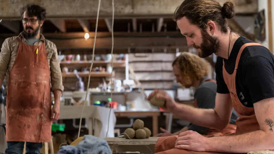 Male student forming clay pieces during a Driving Creek pottery workshop