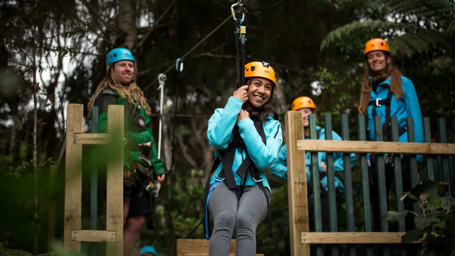 Young woman smiling before launching from the zipline platform in Coromandel