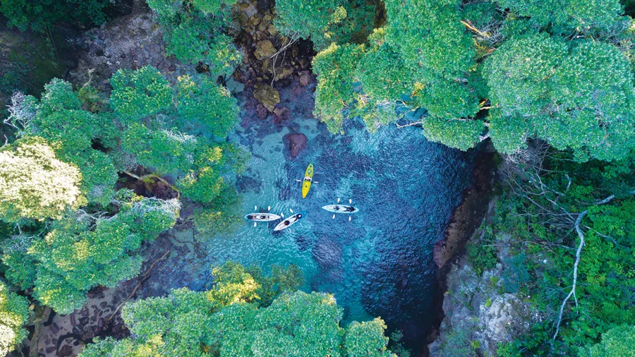 Aerial view of Kayakers at Whenuakura Wildlife Sanctuary Emerald Lagoon Whangamata, Coromandel Peninsula, New Zealand