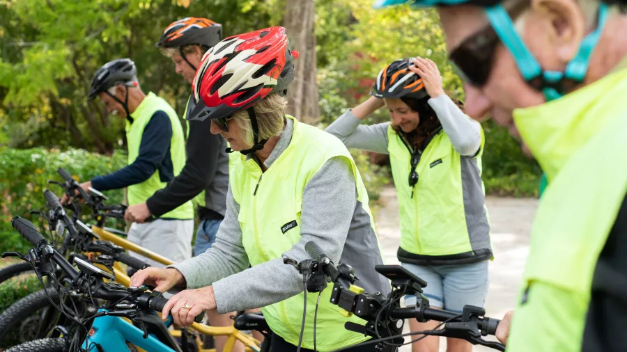 Cyclists preparing their bikes and helmets before starting the Eastwoodhill Express tour