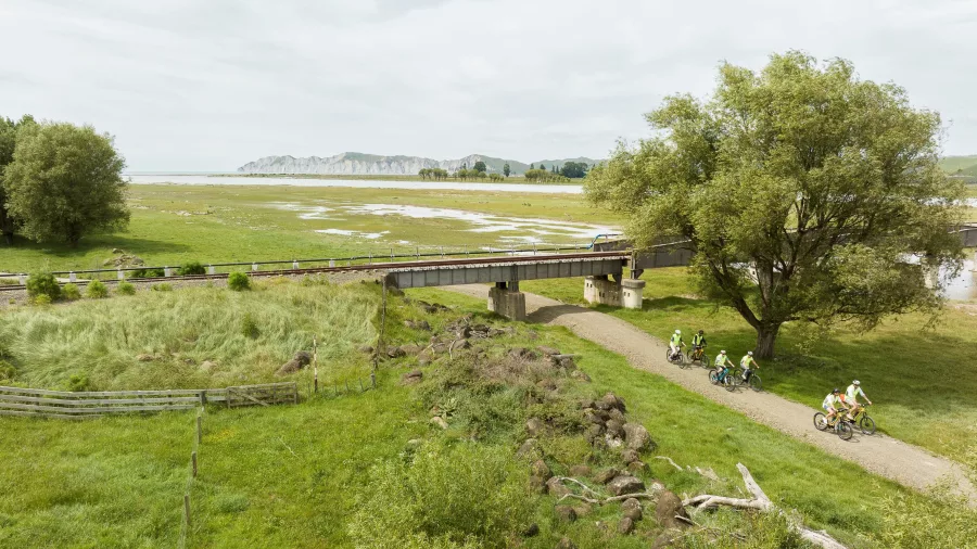 Cyclists approaching a bridge across the Waipaoa River near Gisborne