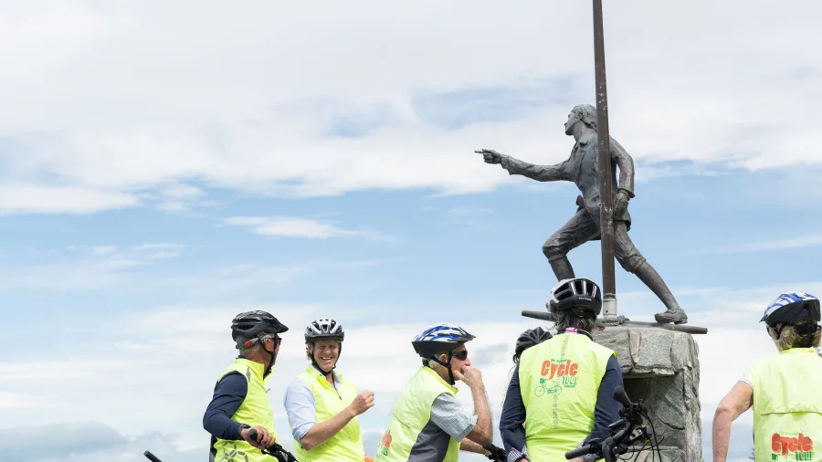 Cyclists gathered around the James Cook statue on the Gisborne waterfront