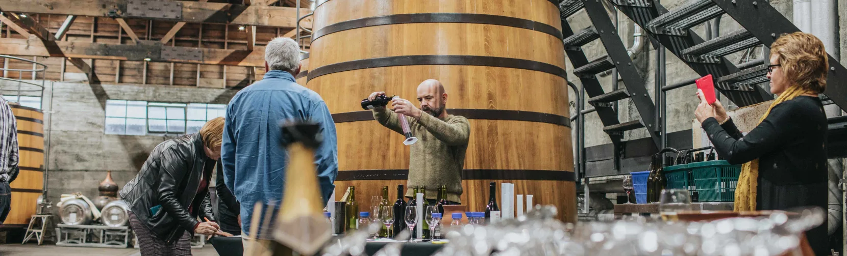 Wine tasting taking place in the fermentation room at Church Road Winery in Hawke’s Bay