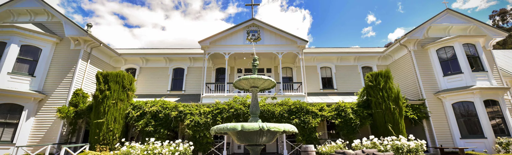 Front view of Mission Estate Winery in Hawke’s Bay with garden and central fountain