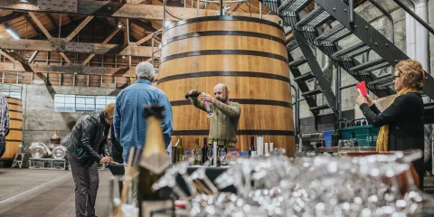 Wine tasting taking place in the fermentation room at Church Road Winery in Hawke’s Bay