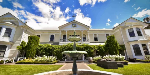 Front view of Mission Estate Winery in Hawke’s Bay with garden and central fountain