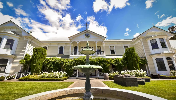 Front view of Mission Estate Winery in Hawke’s Bay with garden and central fountain