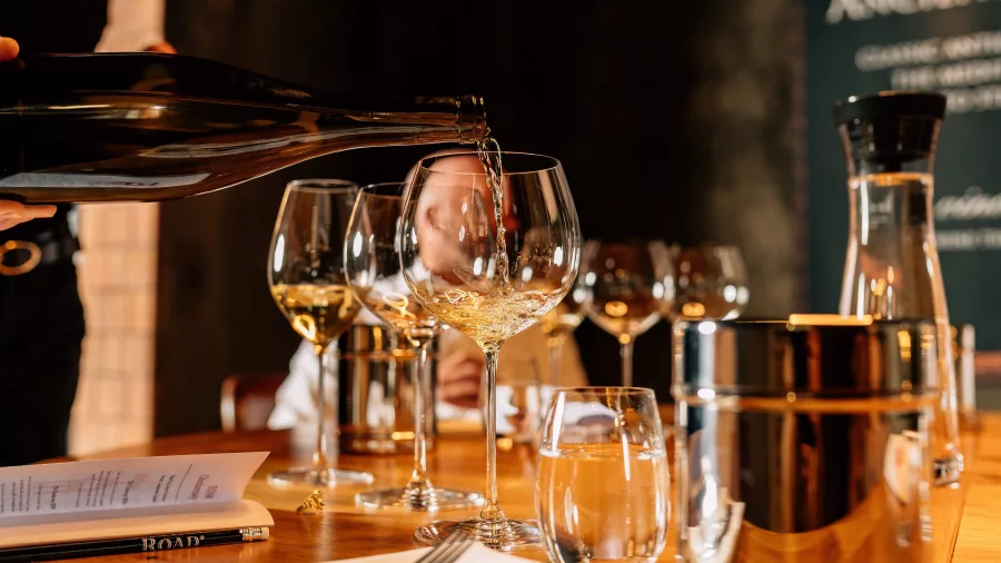 White wine being poured into glasses during a guided tasting at Church Road Winery in Hawke’s Bay