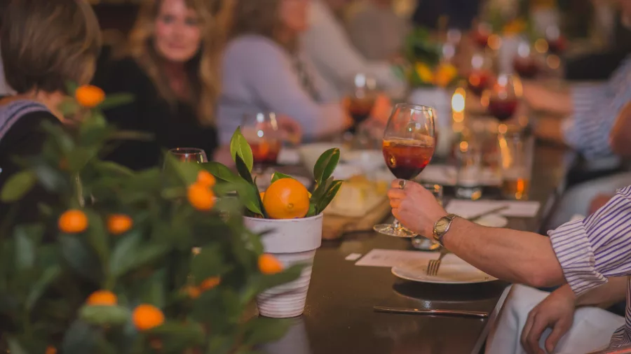 Guests enjoying a cosy winter lunch with wine spritzes at Black Barn Winery