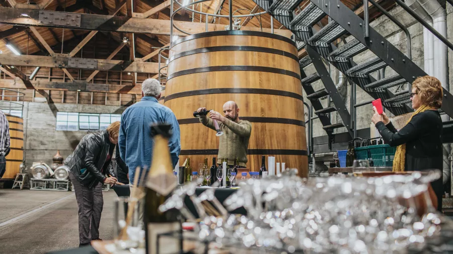 Wine tasting taking place in the fermentation room at Church Road Winery in Hawke’s Bay