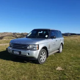 Gannet Safaris branded Range Rover parked on grassy hill during Cape Kidnappers private tour