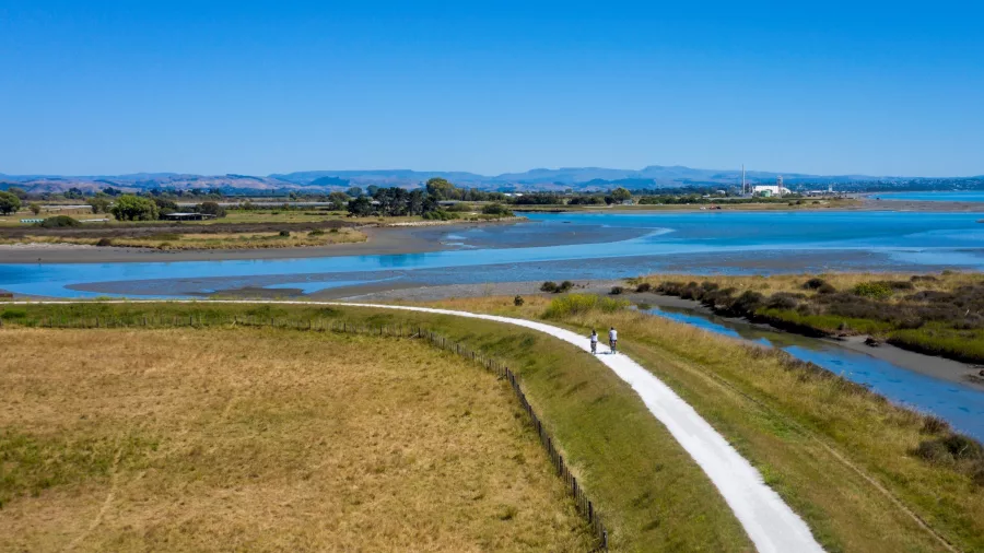 Two cyclists on a gravel trail through the coastal wetlands near Tukituki River in Hawke’s Bay