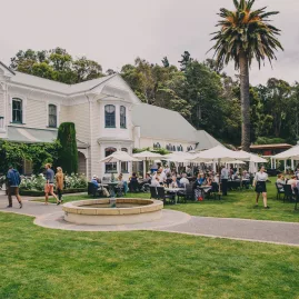 Mission Estate Winery with outdoor dining and visitors enjoying lunch in the garden setting