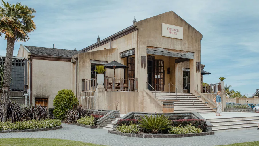 Exterior view of Church Road Winery with steps, patio and landscaped gardens in Hawke’s Bay