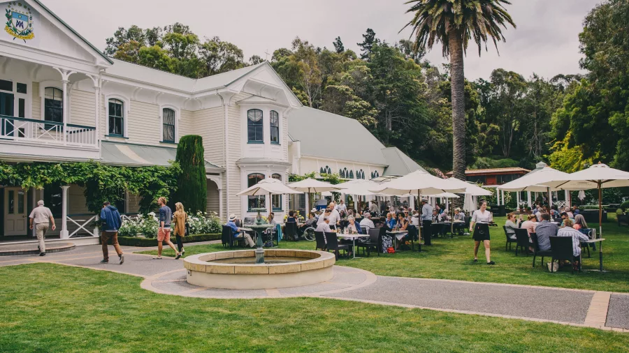 Mission Estate Winery with outdoor dining and visitors enjoying lunch in the garden setting