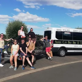 Group of riders posing with bikes next to Napier City Bike Hire shuttle van on the Hawke’s Bay Trails