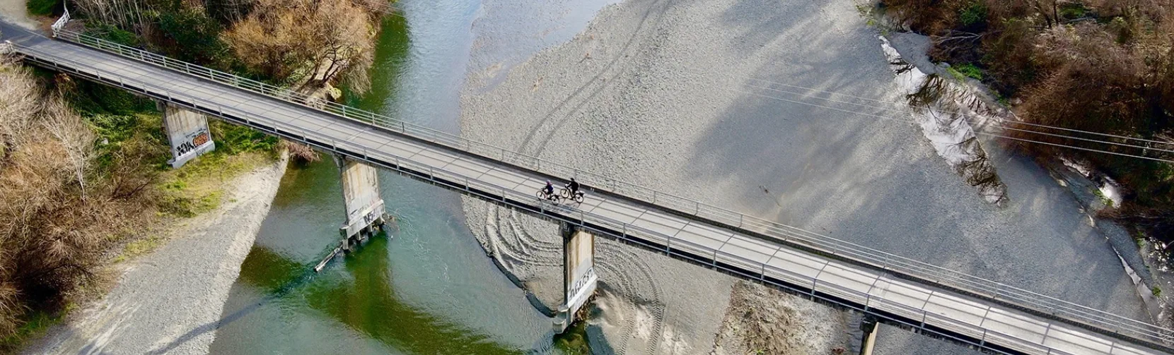 Cyclists crossing the Puketapu Bridge on the Hawke’s Bay Trails over the Tutaekuri River