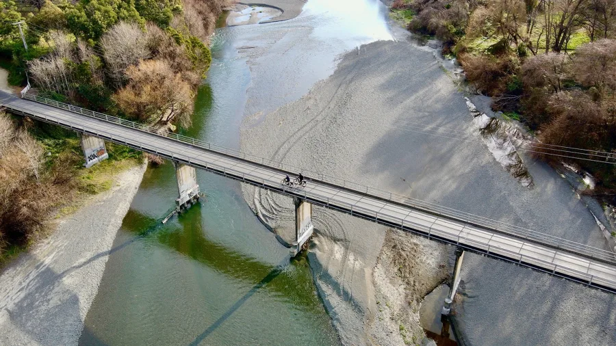 Cyclists crossing the Puketapu Bridge on the Hawke’s Bay Trails over the Tutaekuri River