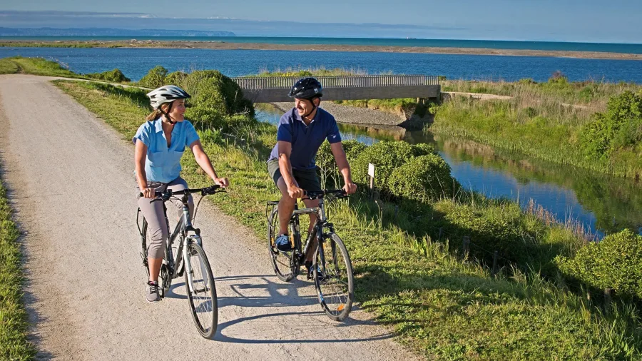 Cycling couple riding beside the Haumoana River on the Hawke’s Bay Cycle Trail