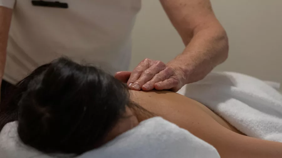 Woman receiving a relaxing back massage at Snowman’s Lodge in Ohakune