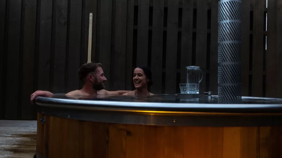 Couple relaxing in a private cedar hot tub at Ohakune Hot Tubs
