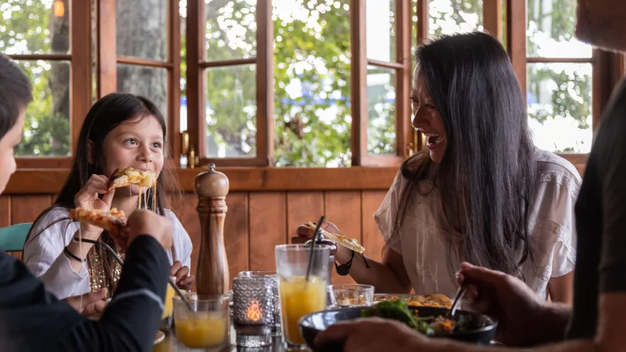 Family sharing a joyful meal at Cyprus Tree Restaurant in Ohakune