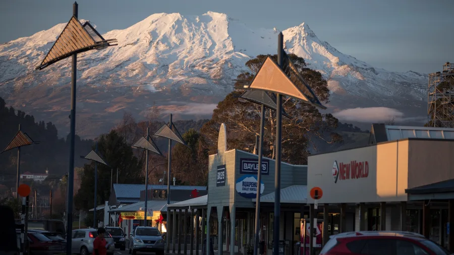 Shops and businesses in Ohakune with morning light on Mount Ruapehu