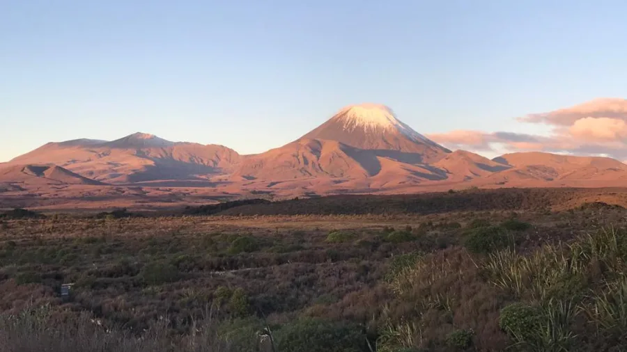 Mount Ngauruhoe glowing at sunset in Tongariro National Park, bathed in golden light
