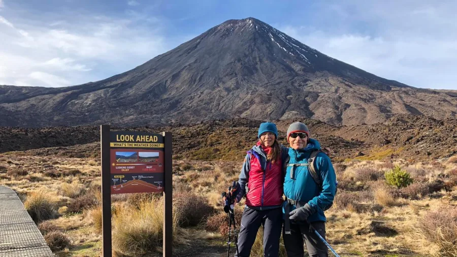 Couple at Tongariro Crossing starting point with volcano in background
