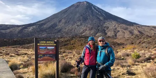 Couple at Tongariro Crossing starting point with volcano in background
