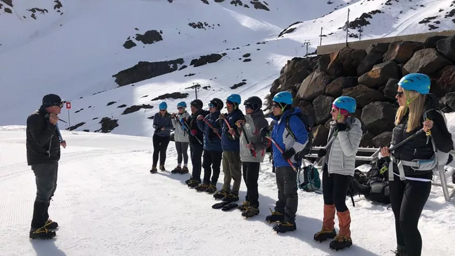 Guided group receiving crampon and ice axe training at the base of Whakapapa on Mt Ruapehu