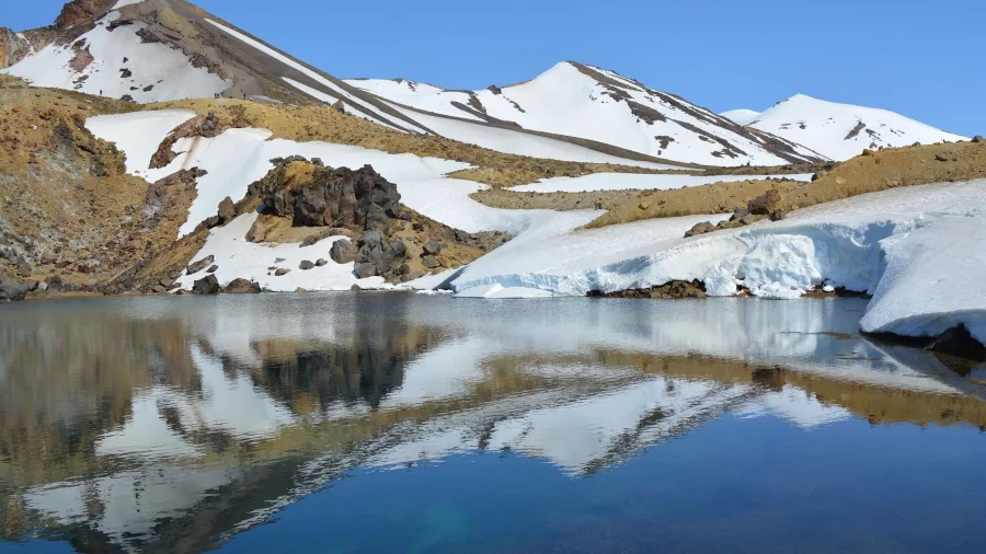 Crater Lake at Mount Ruapehu summit reflecting snowy alpine surroundings