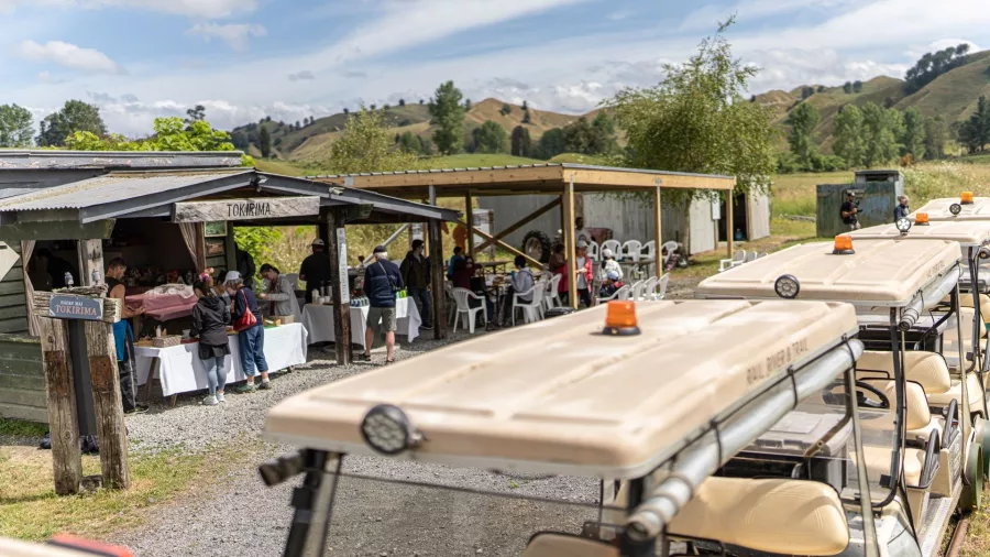 Travellers gathered at Tokirima Station enjoying food and hospitality during the Forgotten World Adventures tour.