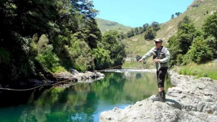 Angler casting from rocks above Storm Rapid on the Rangitikei River