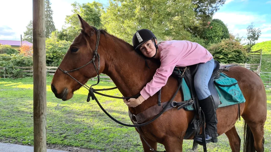 Rider sharing affectionate moment with horse at River Valley