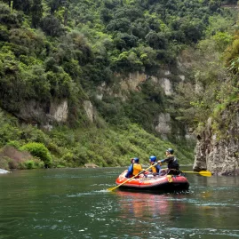 Family rafting through lush green gorges on the Scenic Rangitikei Rafting Tour