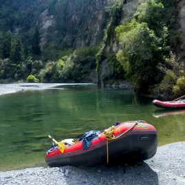 Rafts pulled up on a quiet riverbank during a scenic Rangitikei rafting trip