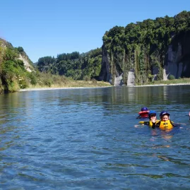 Kids swimming in the clear waters of the Rangitikei River under sunny skies