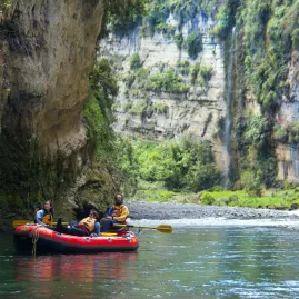Rafters drifting beneath sheer cliffs in the scenic Rangitikei gorge